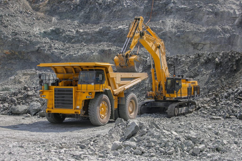 Excavator loads ore into Large dump truck